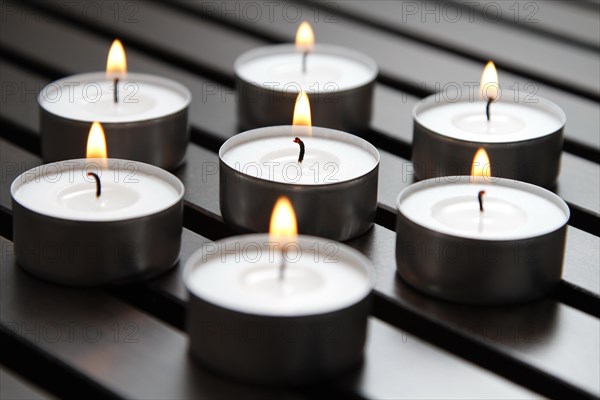 Tea lights on wooden background