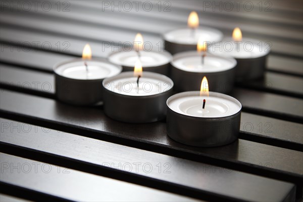 Tea lights on wooden background