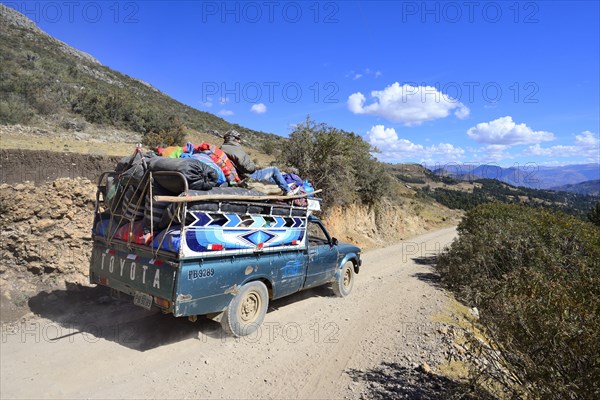 Heavily loaded pickup truck on gravel road