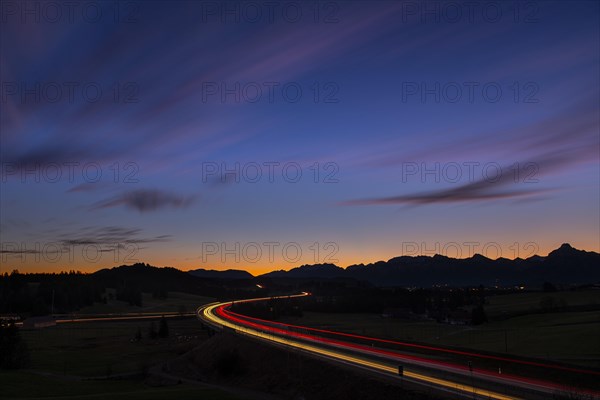 Motorway at blue hour with traces of cars in Allgaeu landscape