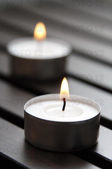 Tea lights on wooden background