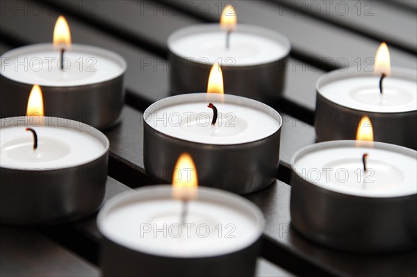 Tea lights on wooden background