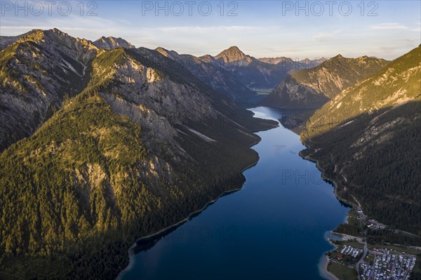 View from the summit of Schoenjoechl to Plansee and mountains at morning sun