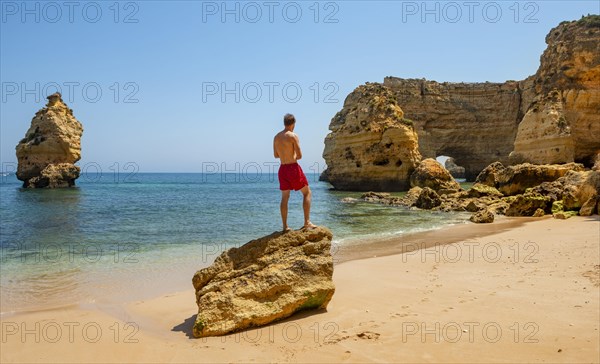 Young man standing on a rock