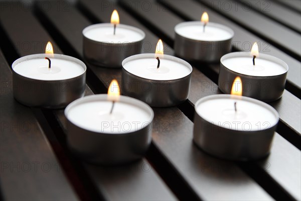 Tea lights on wooden background