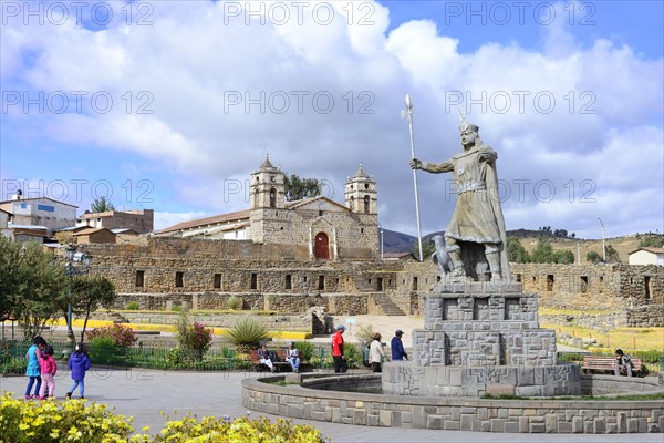 Statue of the Inca Pachacutec in front of sun temple with attached cathedral from the colonial period