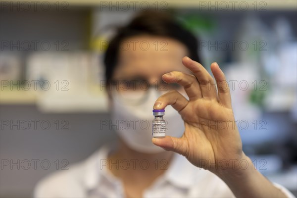 Pharmacist holding Pfizer BioNTech COVID 19 vaccine