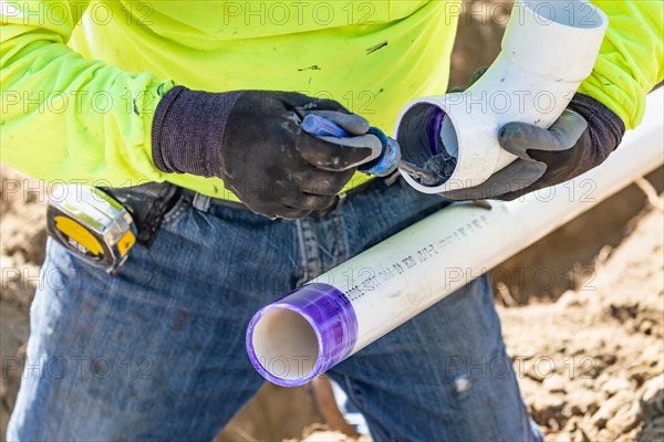 Plumber applying pipe cleaner