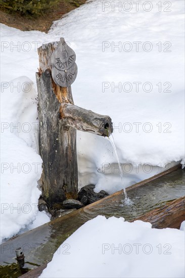Wooden fountain in winter