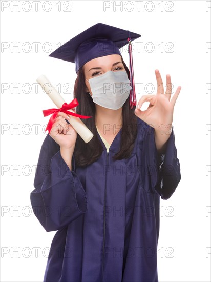 Graduating female wearing medical face mask and cap and gown isolated on a white background