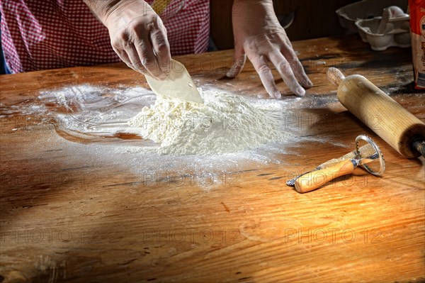 Flour with eggs on wooden table