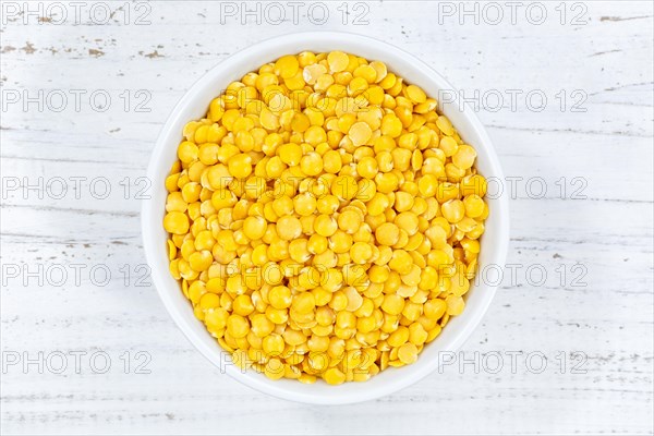 Yellow lentils raw from above wooden board