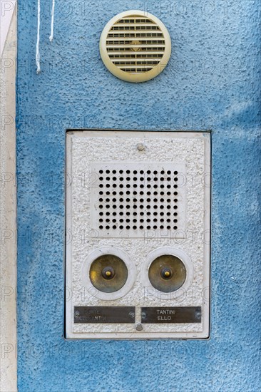 Bell sign on a blue house wall