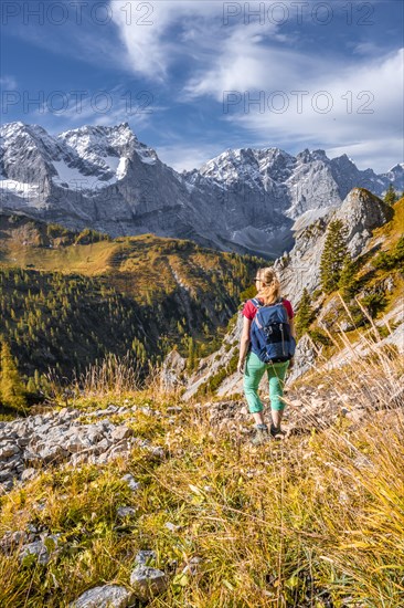 Hiker on hiking trail in the mountains