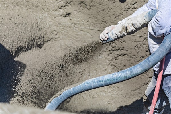 Pool construction worker shooting concrete