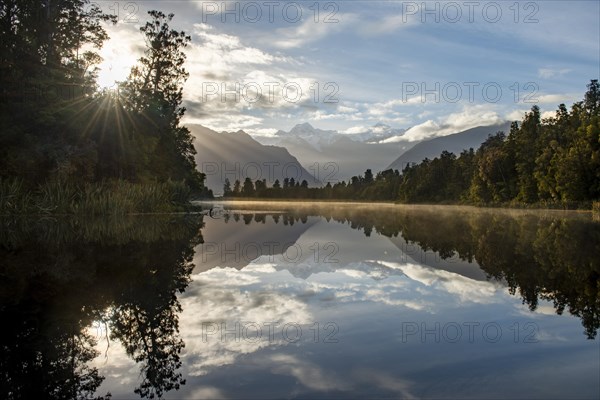 View of Mount Cook in morning light with sun star