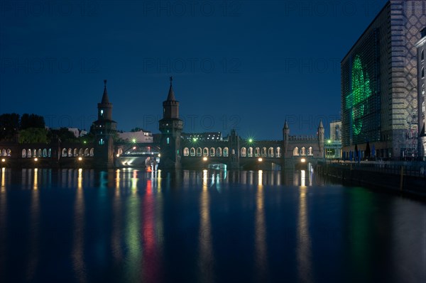 Oberbaum Bridge reflected in the water at night