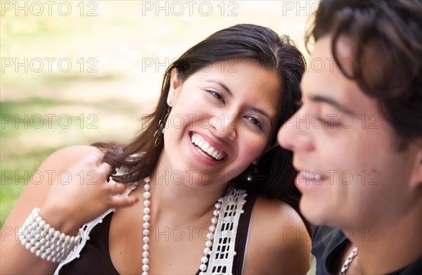 Attractive hispanic couple enjoying themselves at the park