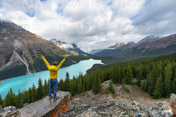 Hiker stretches his arms in the air