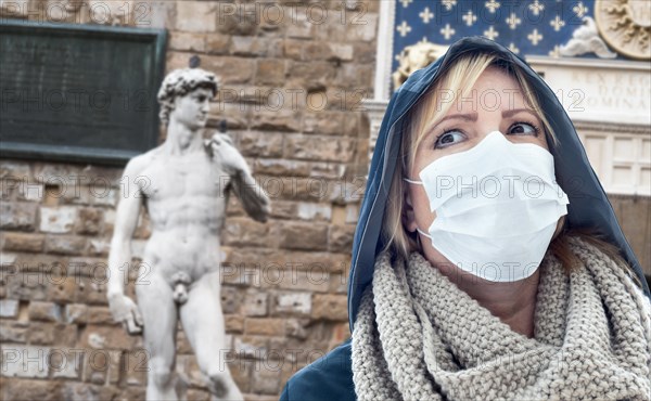 Young Woman Wearing Face Mask Walks Near the Statue of David in the Piazza della Signoria