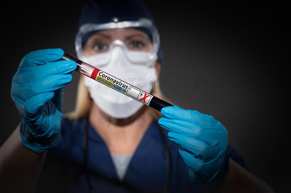 Female Lab Worker Holds Test Tube of Blood Labeled Coronavirus COVID-19 Disease