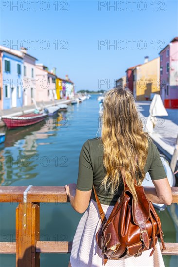 Young woman in front of colorful houses