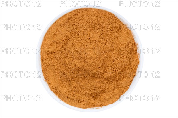 Cinnamon spice powder from above clipping frame against a white background