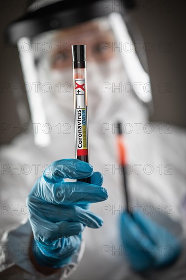 Female Lab Worker Holds Test Tube of Blood Labeled Coronavirus COVID-19 Disease