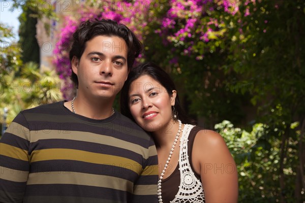 Happy attractive hispanic couple enjoying themselves at the park