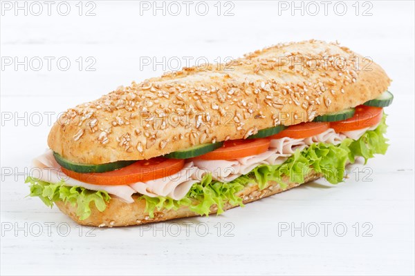 Roll baguette wholemeal topped with ham on wooden board