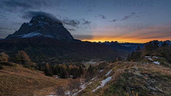 Peak of Monte Pelmo at sunrise with autumn landscape