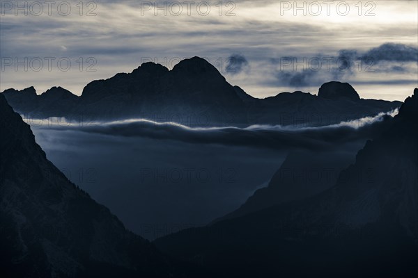 Mountain top of the Dolomites with dramatic cloudy sky