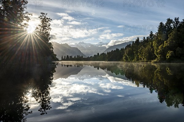 View of Mount Cook and Mount Tasman in morning light with sun star