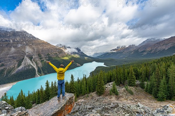 Hiker stretches his arms in the air
