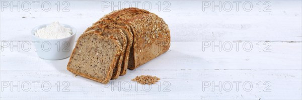 Bread multigrain bread wholemeal bread grain bread cut slice banner text free space on wooden plate