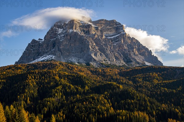 Peak of Monte Pelmo at sunrise with autumn landscape