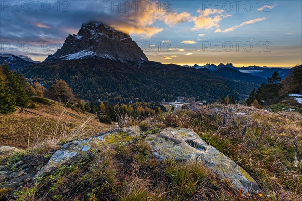 Peak of Monte Pelmo at sunrise with autumn landscape