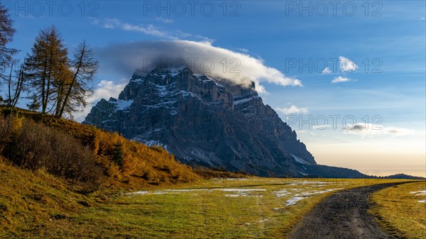 Peak of Monte Pelmo in the morning light with autumn landscape