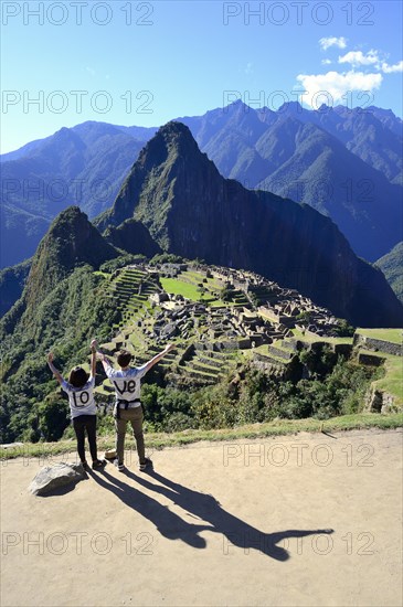 Two tourists wearing T-shirts with Love on them in the ruined city of the Incas