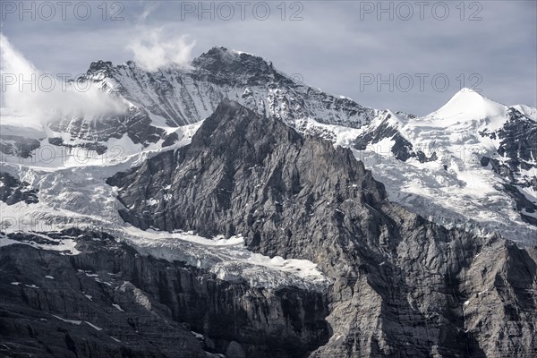 Snow covered mountain peaks Jungfrau and Silberhorn with glacier Jungfraufirn