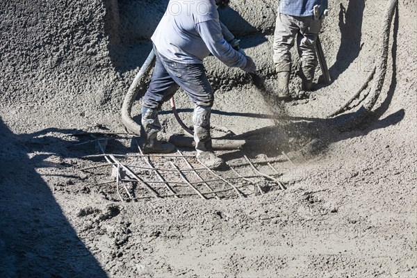 Pool construction worker shooting concrete