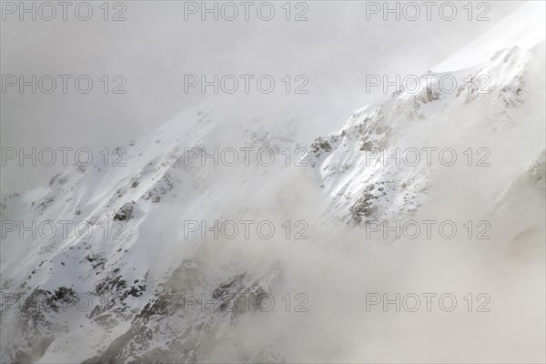 Rock slope behind clouds