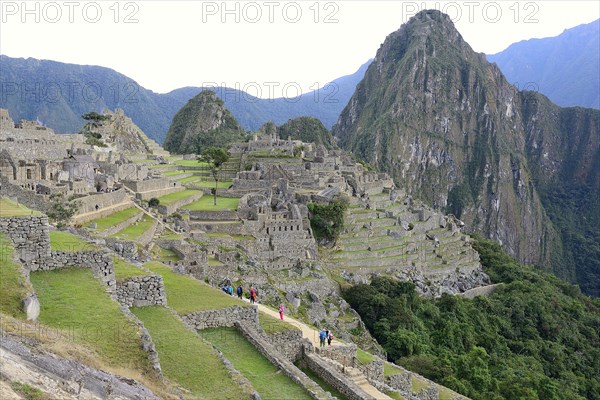 Inca ruined city with Mount Huayna Picchu at dawn