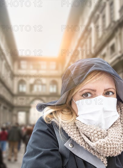 Young Woman Wearing Face Mask Walks Near the Uffizi Gallery