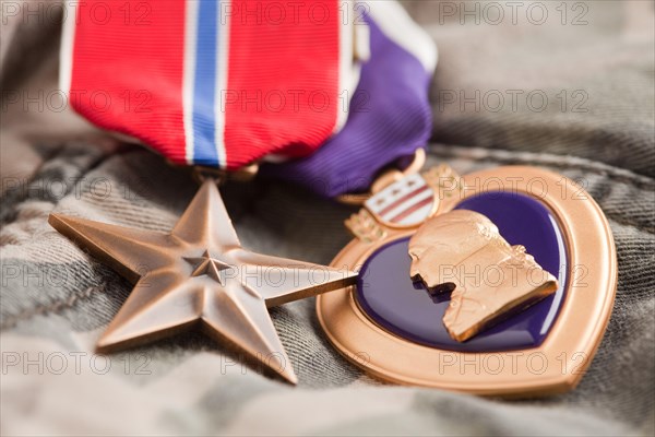 Bronze and purple heart medals on camouflage material