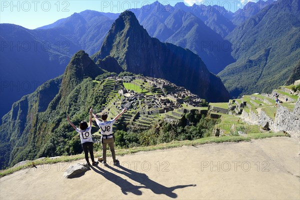 Two tourists wearing T-shirts with Love on them in the ruined city of the Incas