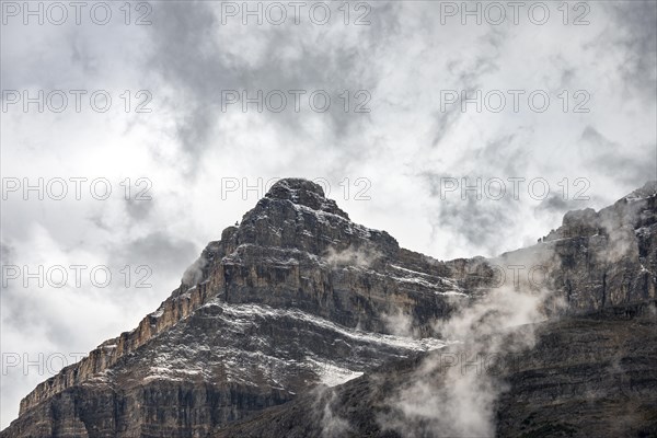 Snowy mountain top covered with clouds