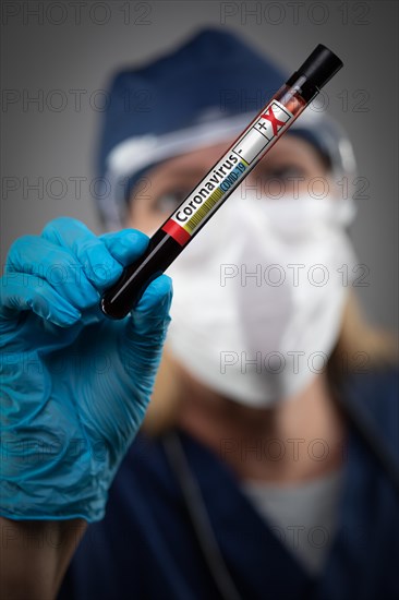 Female Lab Worker Holds Test Tube of Blood Labeled Coronavirus COVID-19 Disease