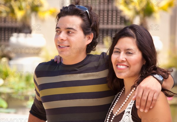 Attractive hispanic couple enjoying themselves at the park