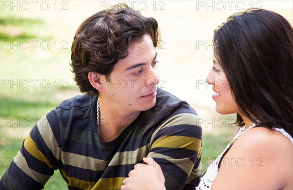 Attractive hispanic couple enjoying themselves at the park